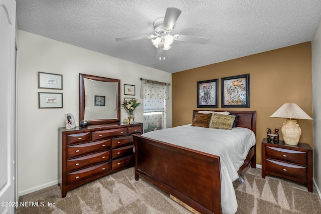 carpeted bedroom featuring baseboards, a textured ceiling, and ceiling fan