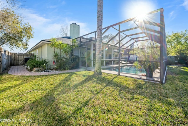 view of yard with a lanai, a fenced backyard, a fenced in pool, and a patio