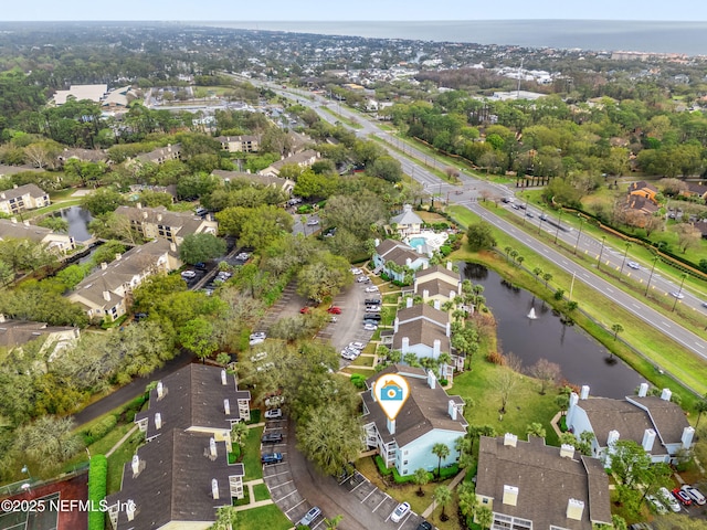 drone / aerial view with a residential view and a water view