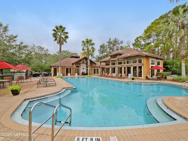 pool featuring a patio and fence