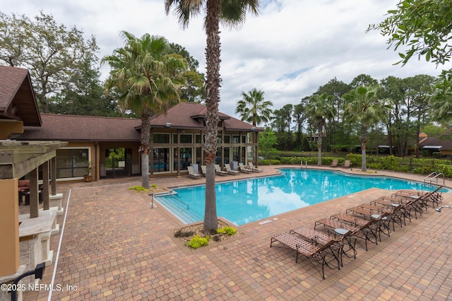 pool featuring a patio and fence