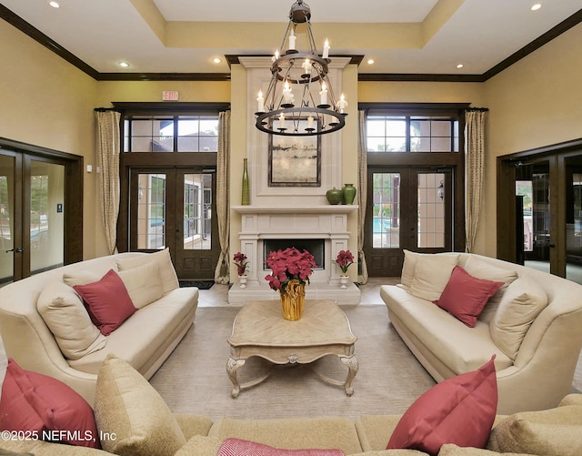 living room featuring a wealth of natural light, french doors, and crown molding