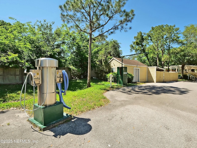 exterior space with a playground, a front yard, and fence