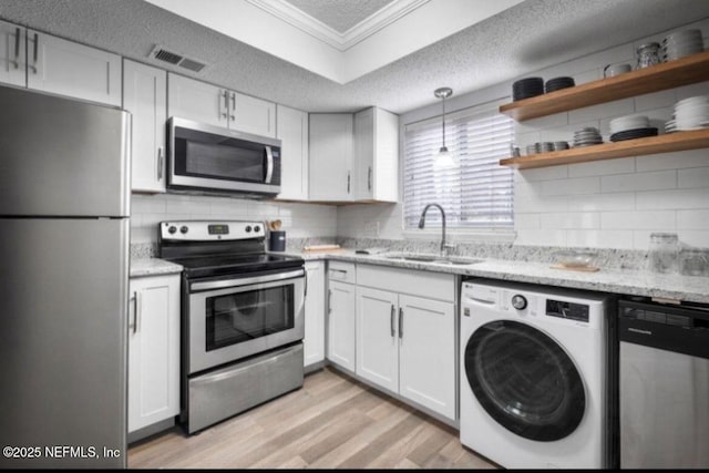 6655 Bell Tower Ct Unit 7, Jacksonville, FL 32217 - kitchen with a textured ceiling, visible vents, washer / clothes dryer, stainless steel appliances, and a sink