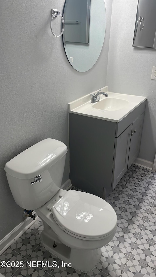 6655 Bell Tower Ct Unit 7, Jacksonville, FL 32217 - half bath featuring baseboards, toilet, and vanity
