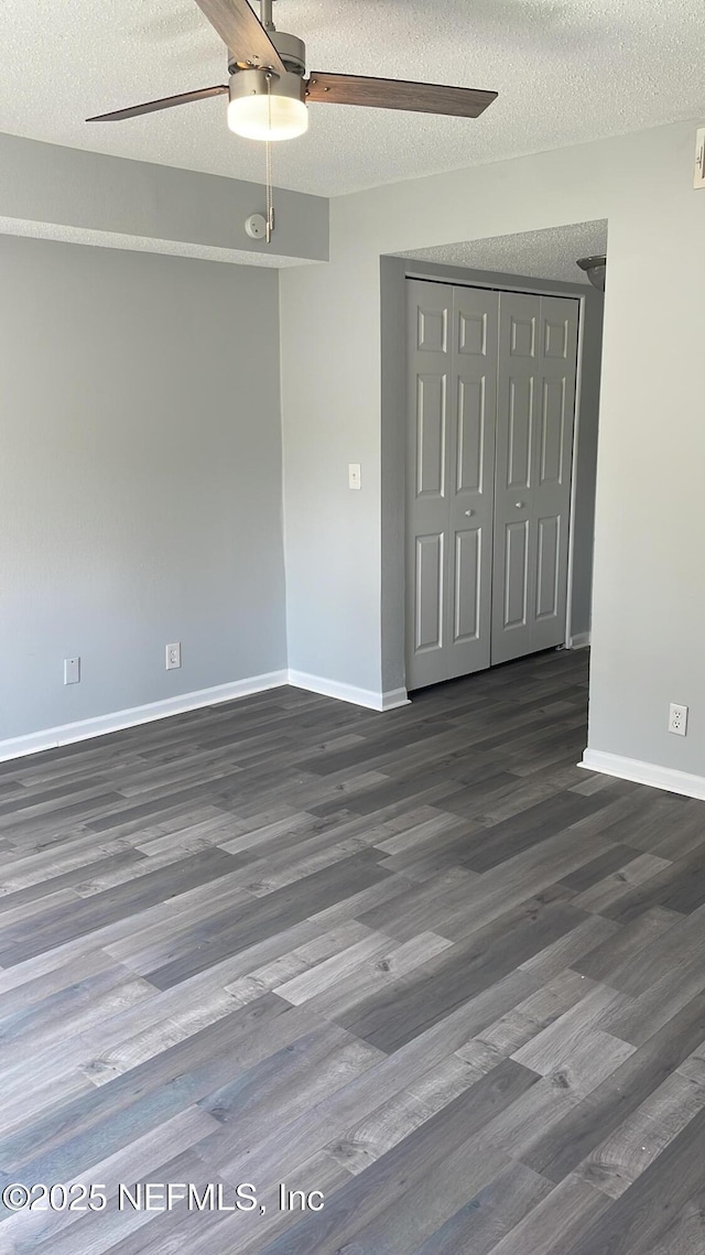 6655 Bell Tower Ct Unit 7, Jacksonville, FL 32217 - unfurnished room featuring a ceiling fan, a textured ceiling, baseboards, and wood finished floors