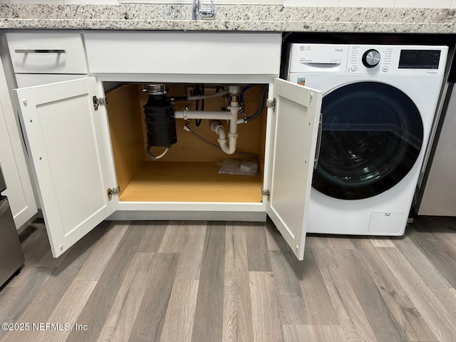 6655 Bell Tower Ct Unit 7, Jacksonville, FL 32217 - clothes washing area with washer / clothes dryer, laundry area, and wood finished floors