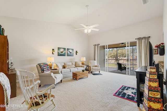 carpeted living area featuring lofted ceiling, a ceiling fan, and visible vents