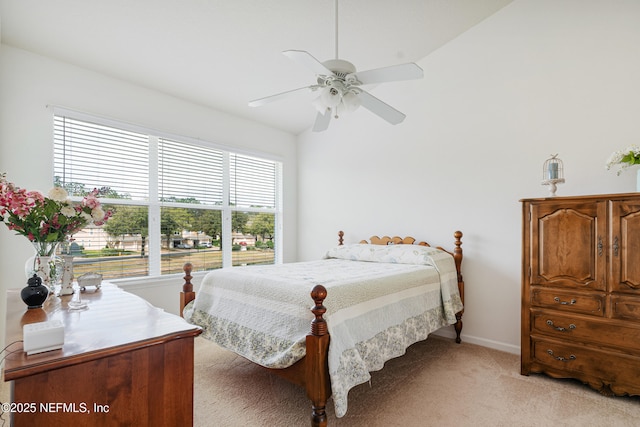 bedroom featuring a ceiling fan, baseboards, and light carpet