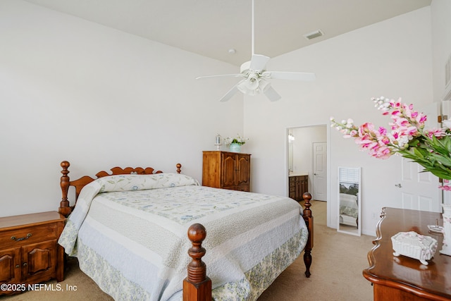 bedroom with light carpet, visible vents, and a towering ceiling