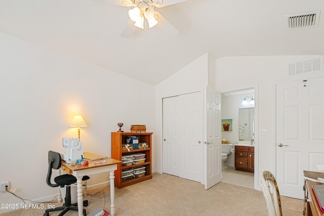 office area featuring ceiling fan, lofted ceiling, visible vents, and light carpet