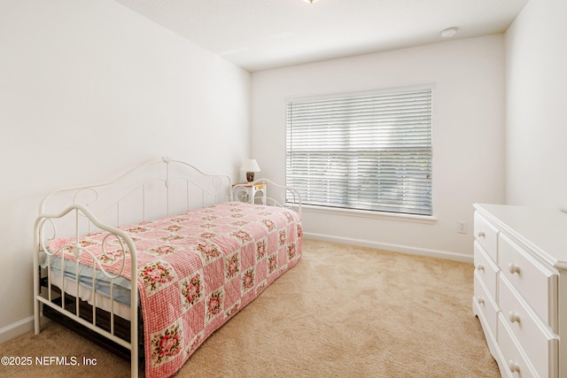 carpeted bedroom featuring baseboards