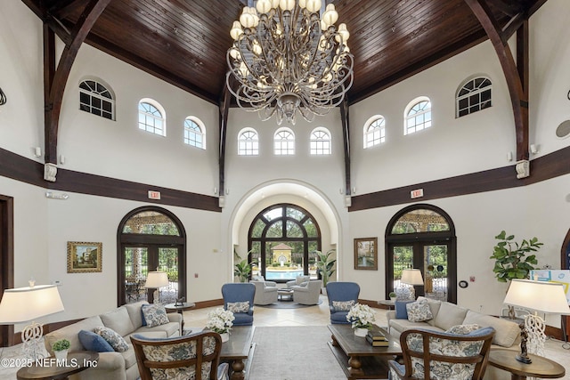 living room featuring french doors, arched walkways, wood ceiling, and a chandelier