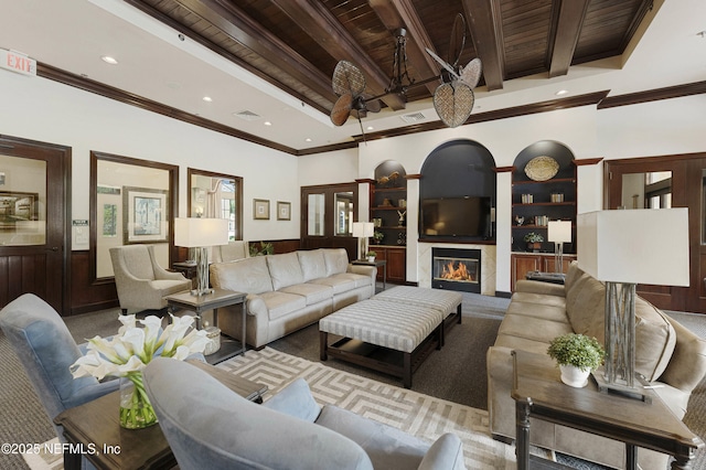 living area featuring a high end fireplace, visible vents, beamed ceiling, and wooden ceiling