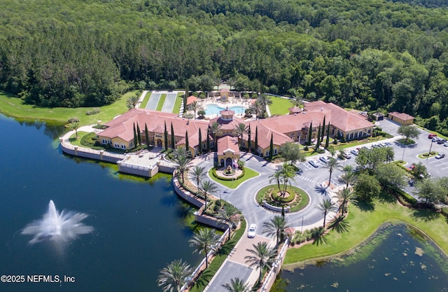 aerial view featuring a forest view and a water view