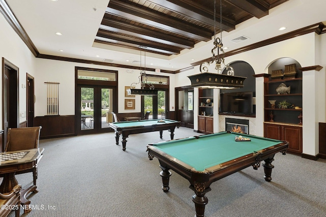 game room featuring a wainscoted wall, beam ceiling, billiards, a glass covered fireplace, and french doors