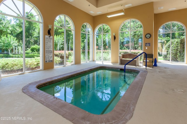 view of pool with a patio, a pool, and a lanai