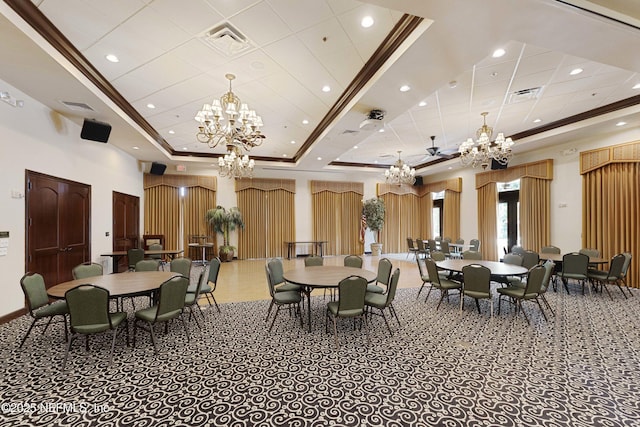 dining area featuring visible vents, a raised ceiling, and a notable chandelier