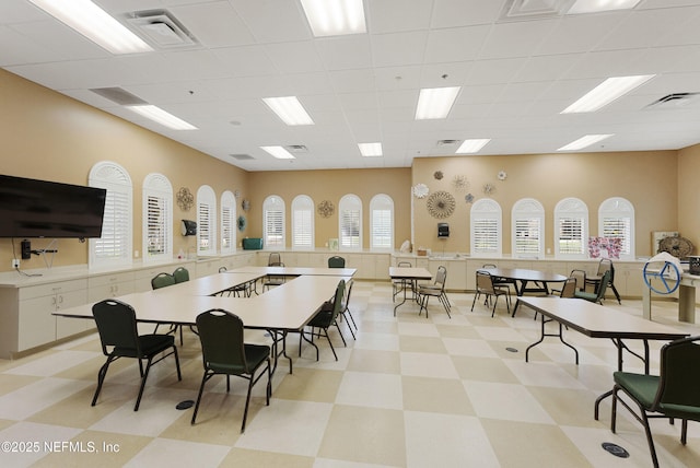 dining area featuring visible vents, a paneled ceiling, and light floors