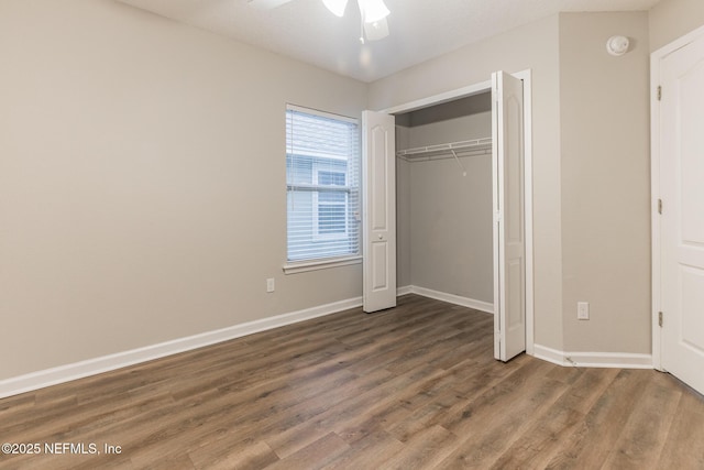 unfurnished bedroom with ceiling fan, a closet, baseboards, and wood finished floors