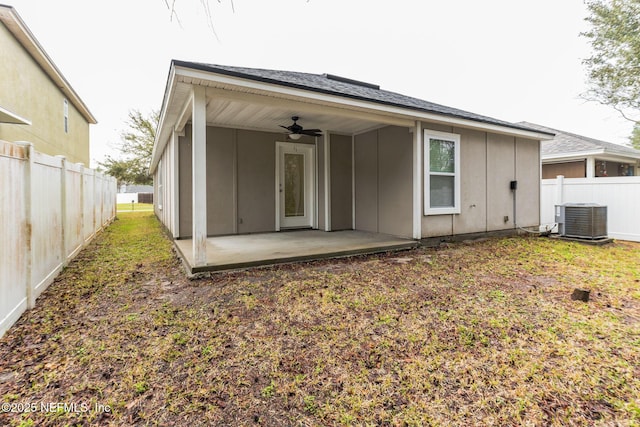 back of house with a ceiling fan, fence, central air condition unit, a patio area, and board and batten siding