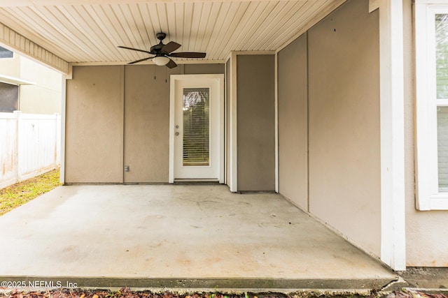 view of patio with ceiling fan and fence