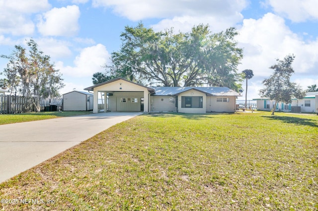 single story home featuring an attached carport, a front lawn, fence, and driveway