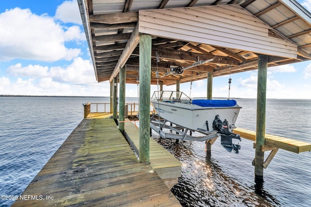 view of dock featuring boat lift and a water view