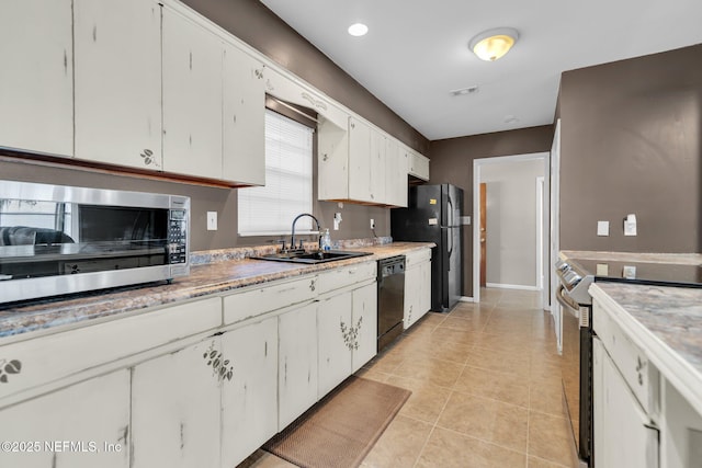 kitchen featuring white cabinetry, black appliances, light tile patterned flooring, and a sink