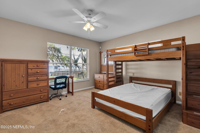 bedroom featuring baseboards and light colored carpet