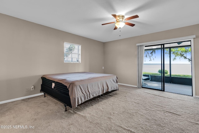 carpeted bedroom featuring baseboards, ceiling fan, and access to outside