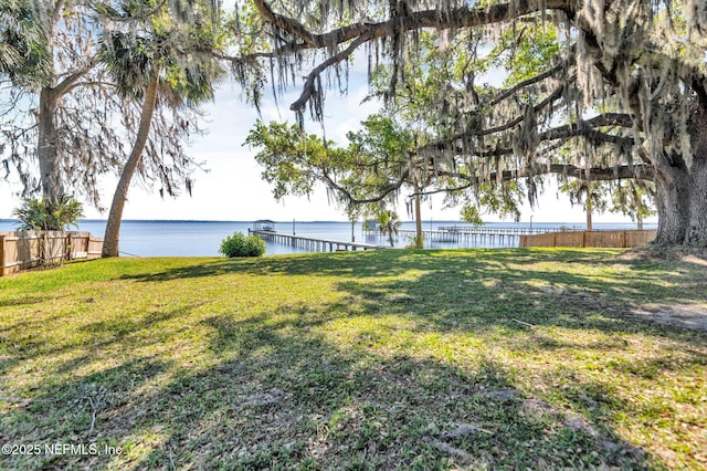 view of yard featuring fence and a water view