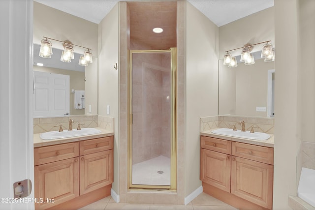 bathroom featuring a sink, two vanities, and a shower stall