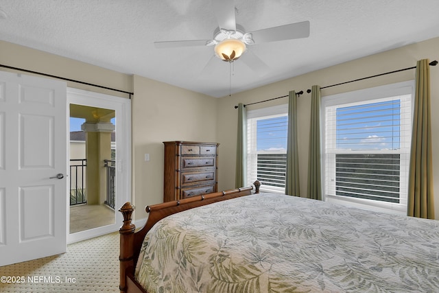 bedroom with a textured ceiling and a ceiling fan