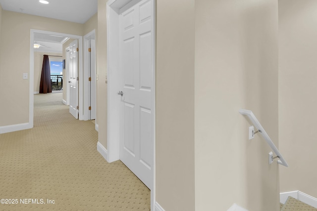 corridor featuring recessed lighting, an upstairs landing, light colored carpet, and baseboards