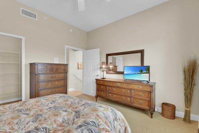 bedroom featuring baseboards, visible vents, a closet, and ceiling fan