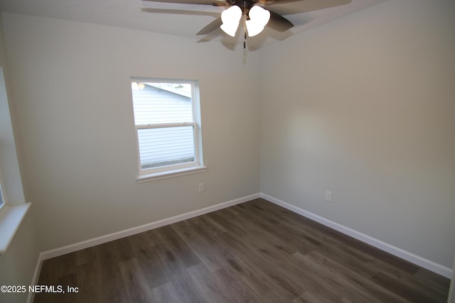 empty room featuring dark wood-type flooring, baseboards, and ceiling fan