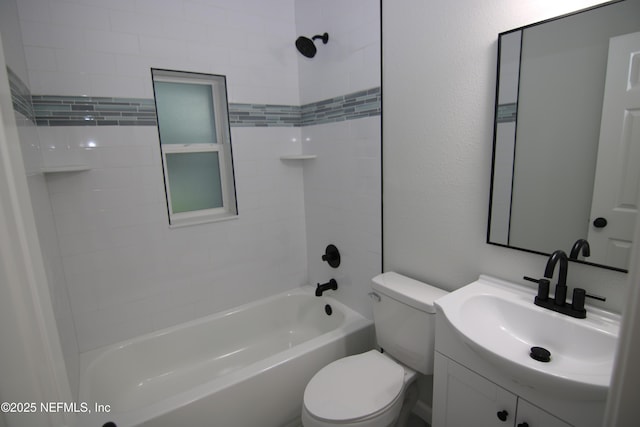 bathroom with vanity, toilet,  shower combination, and a textured wall