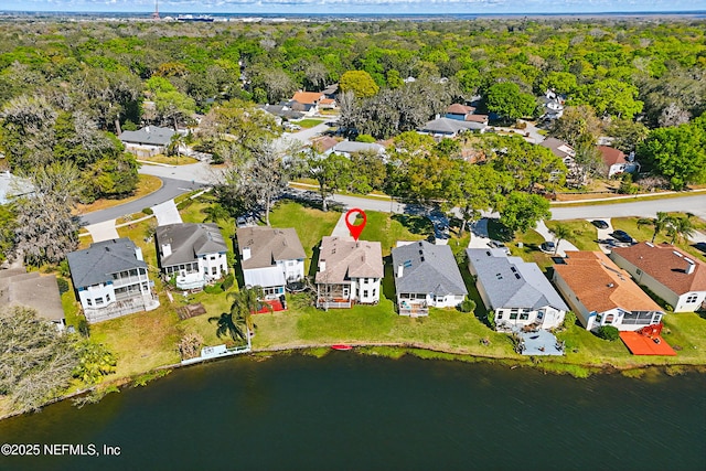 bird's eye view with a residential view, a wooded view, and a water view