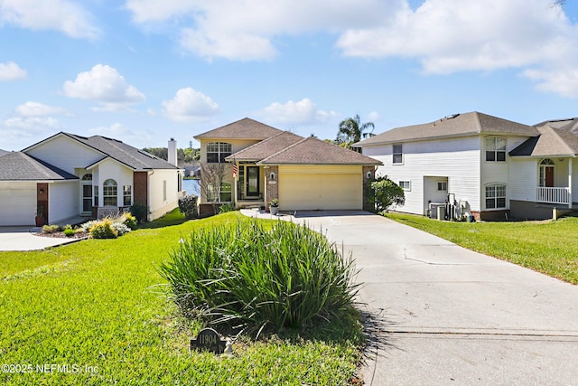 view of front facade with a front lawn, concrete driveway, brick siding, and an attached garage