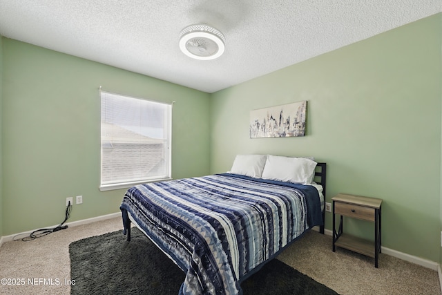 bedroom with carpet, baseboards, and a textured ceiling