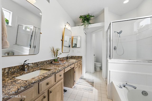 full bath with tile patterned flooring, toilet, a bath, and a sink