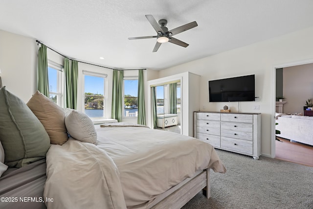 bedroom with carpet flooring, a ceiling fan, and baseboards