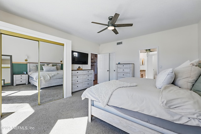 carpeted bedroom featuring a ceiling fan, visible vents, and ensuite bathroom