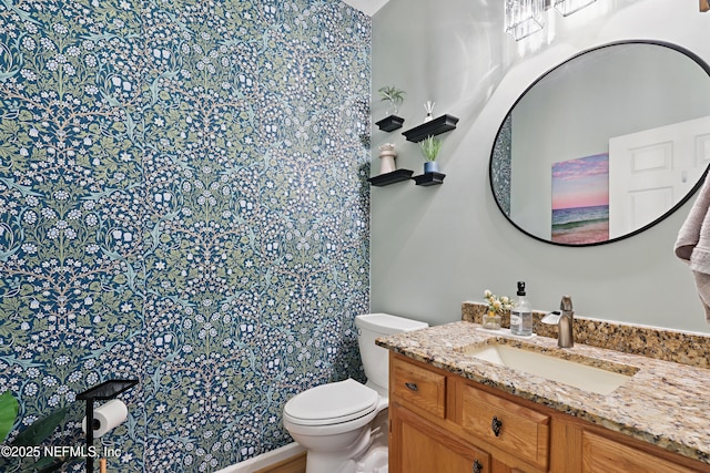 bathroom with toilet and vanity