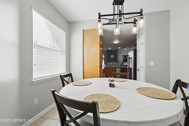 dining room featuring baseboards and light tile patterned flooring