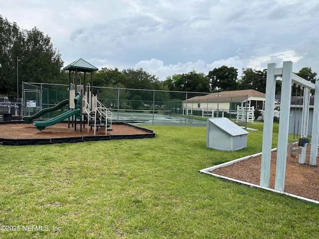 community play area with a yard and fence