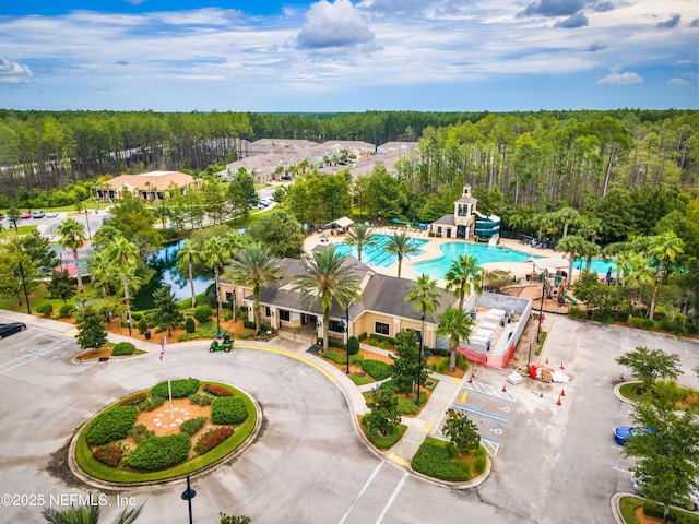 birds eye view of property featuring a wooded view