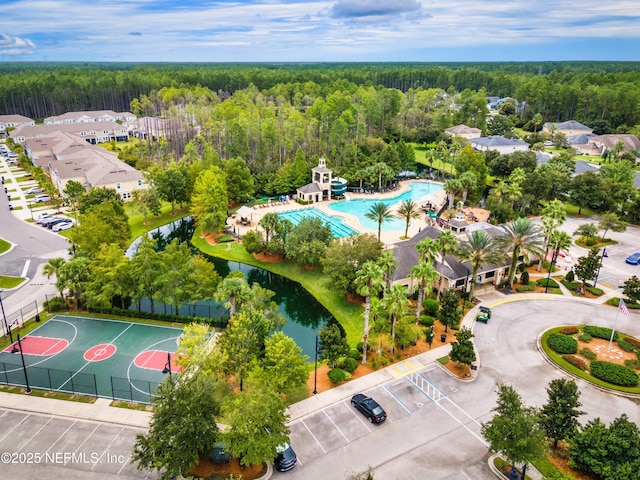 aerial view with a forest view and a water view