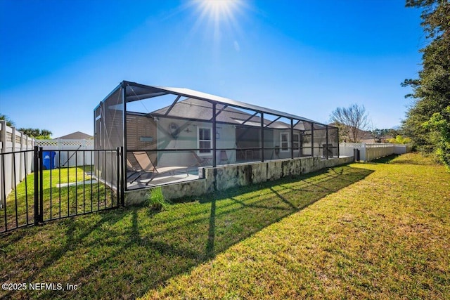 view of yard with glass enclosure and a fenced backyard